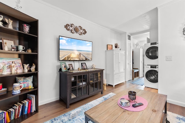 610 Putters Ln Unit H-109, Little River, SC 29566 - living area featuring baseboards, visible vents, stacked washer / dryer, and wood finished floors