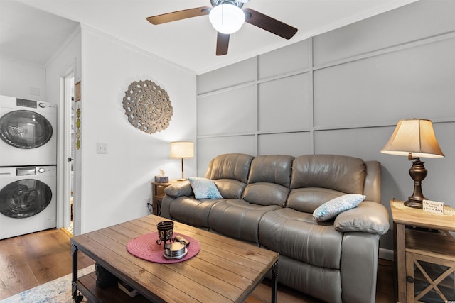 610 Putters Ln Unit H-109, Little River, SC 29566 - living room featuring ornamental molding, ceiling fan, wood finished floors, and stacked washer / dryer