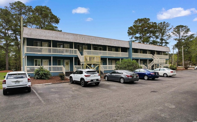 610 Putters Ln Unit H-109, Little River, SC 29566 - view of building exterior with uncovered parking and stairway