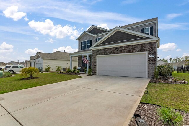 7037 Grant St, Little River, SC 29566 - view of front of home featuring brick siding, concrete driveway, and a front lawn
