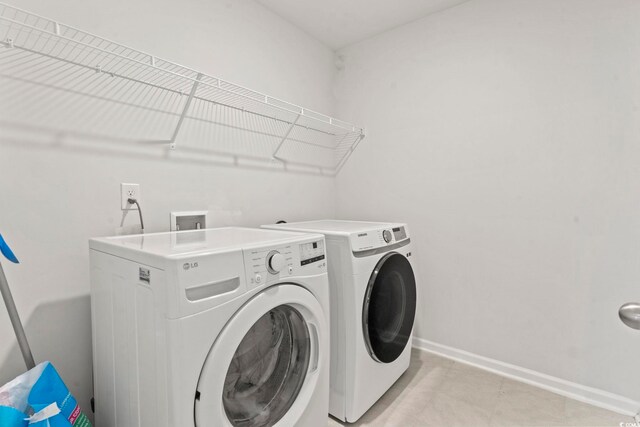 7037 Grant St, Little River, SC 29566 - laundry area featuring washing machine and dryer and baseboards