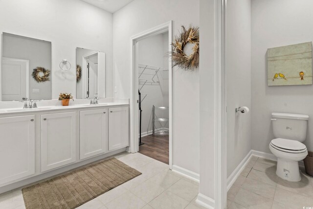 7037 Grant St, Little River, SC 29566 - bathroom featuring toilet, double vanity, tile patterned flooring, and baseboards