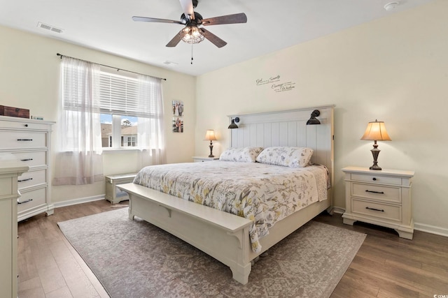 7037 Grant St, Little River, SC 29566 - bedroom featuring wood finished floors, baseboards, and a ceiling fan