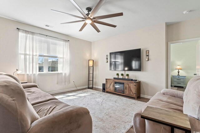 7037 Grant St, Little River, SC 29566 - living area with a ceiling fan, baseboards, and wood finished floors