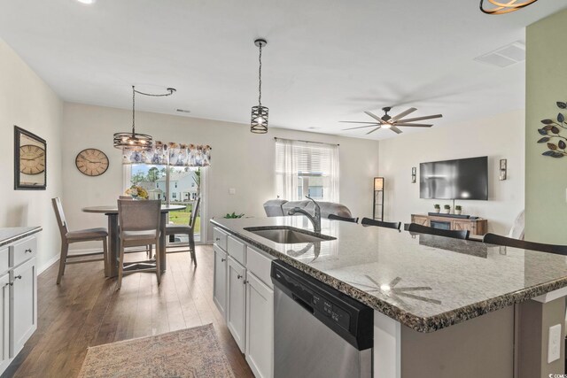 7037 Grant St, Little River, SC 29566 - kitchen with dishwasher, a sink, a center island with sink, wood finished floors, and open floor plan
