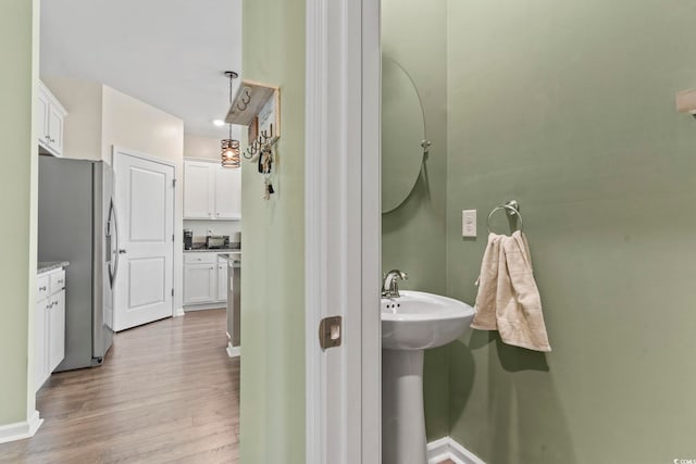 7037 Grant St, Little River, SC 29566 - bathroom featuring wood finished floors, baseboards, and a sink