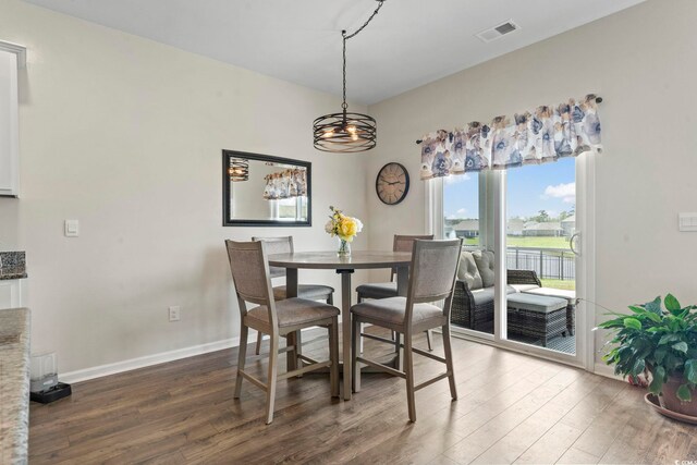 7037 Grant St, Little River, SC 29566 - dining space with wood finished floors, a chandelier, and baseboards