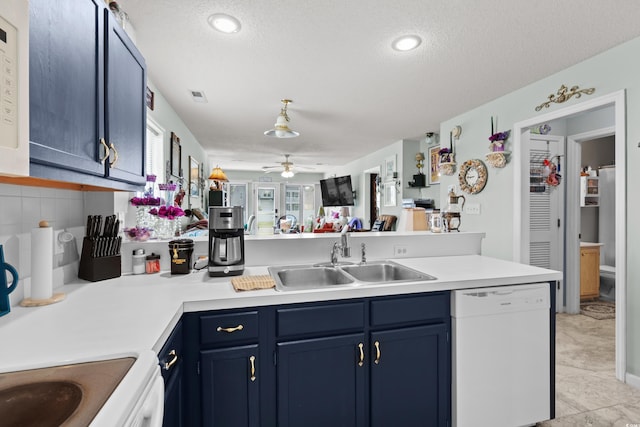 213 Landing Rd Unit A, North Myrtle Beach, SC 29582 - kitchen with dishwasher, a sink, blue cabinets, a peninsula, and light countertops