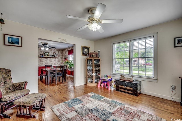 playroom with hardwood / wood-style floors, baseboards, and a ceiling fan