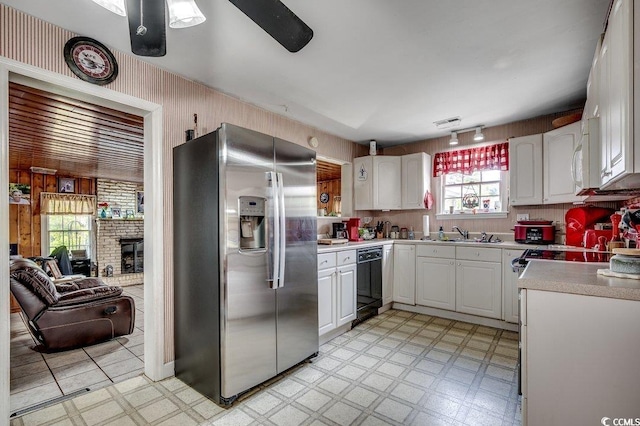 kitchen featuring ceiling fan, light floors, stainless steel refrigerator with ice dispenser, dishwasher, and light countertops