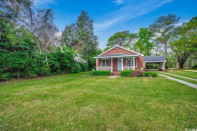 view of front of property featuring brick siding, a porch, an attached carport, and a front lawn