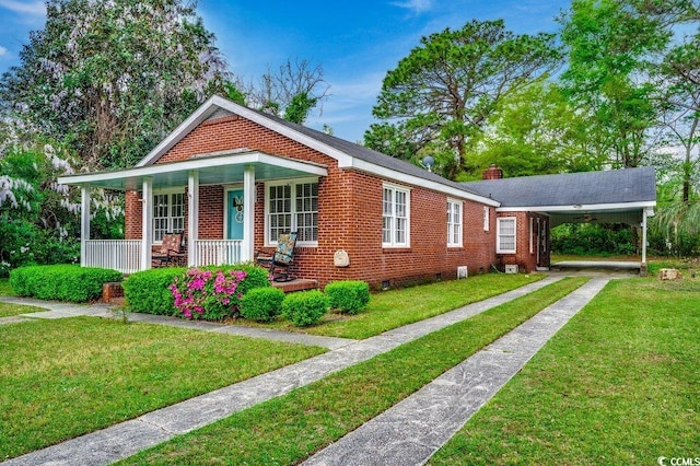 view of front of home with driveway, an attached carport, a front yard, brick siding, and a porch