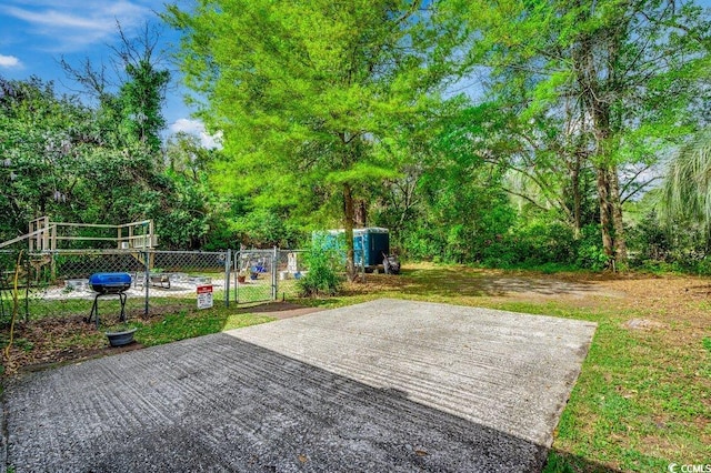 view of patio featuring fence and a gate