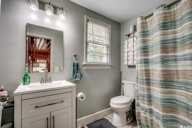bathroom featuring vanity, tile patterned flooring, toilet, curtained shower, and baseboards