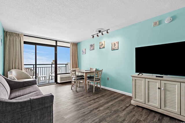 1501 S Ocean Blvd Unit 845, Myrtle Beach, SC 29577 - living area with floor to ceiling windows, dark wood-type flooring, and a textured ceiling