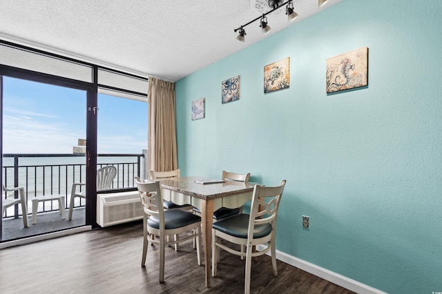 1501 S Ocean Blvd Unit 845, Myrtle Beach, SC 29577 - dining room featuring baseboards, floor to ceiling windows, a textured ceiling, dark wood-type flooring, and rail lighting