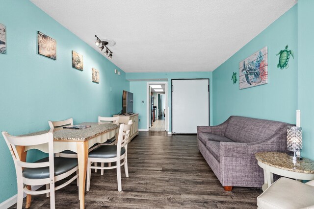 1501 S Ocean Blvd Unit 845, Myrtle Beach, SC 29577 - dining area featuring a textured ceiling, baseboards, and wood finished floors