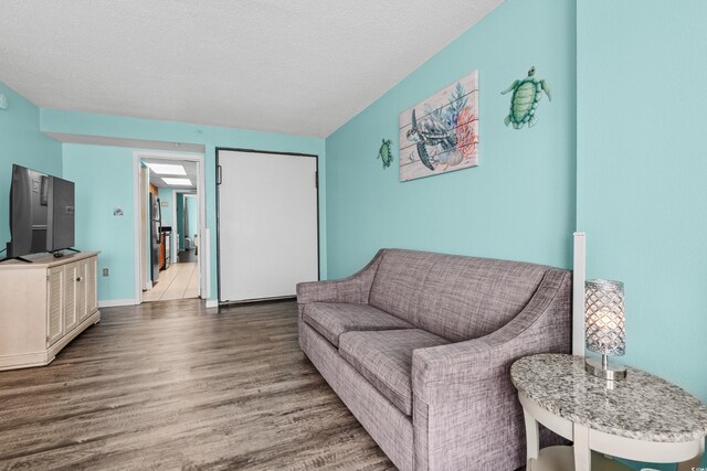1501 S Ocean Blvd Unit 845, Myrtle Beach, SC 29577 - living area featuring a textured ceiling, baseboards, and wood finished floors