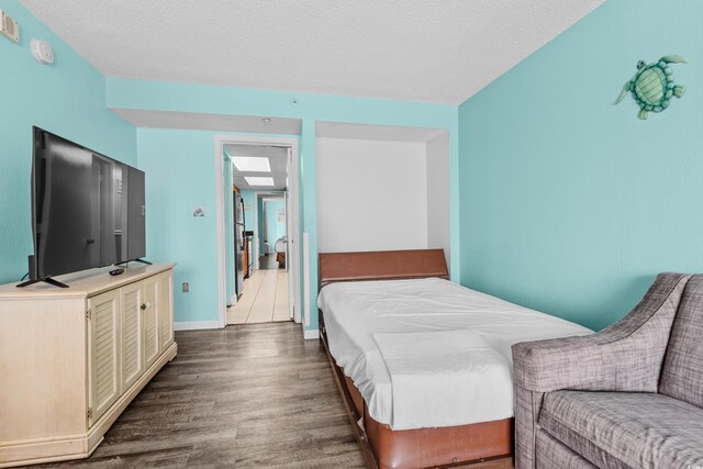 1501 S Ocean Blvd Unit 845, Myrtle Beach, SC 29577 - bedroom with dark wood-style flooring, a textured ceiling, and baseboards