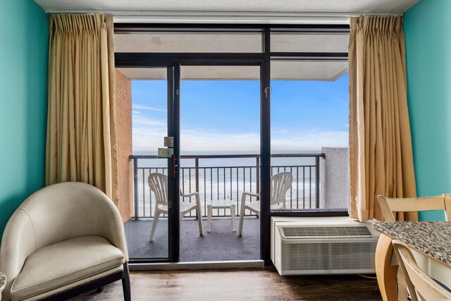 1501 S Ocean Blvd Unit 845, Myrtle Beach, SC 29577 - bedroom with a wall mounted air conditioner, dark wood-type flooring, and a wall of windows