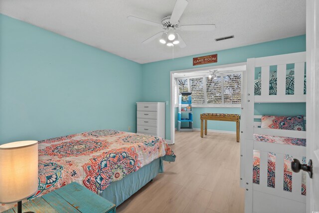 1521 Edge Dr, North Myrtle Beach, SC 29582 - bedroom with visible vents, baseboards, a ceiling fan, and wood finished floors