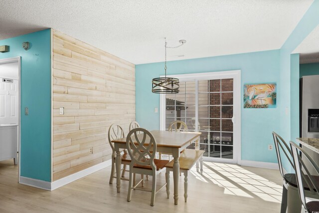 1521 Edge Dr, North Myrtle Beach, SC 29582 - dining space featuring wood walls, baseboards, a chandelier, and a textured ceiling