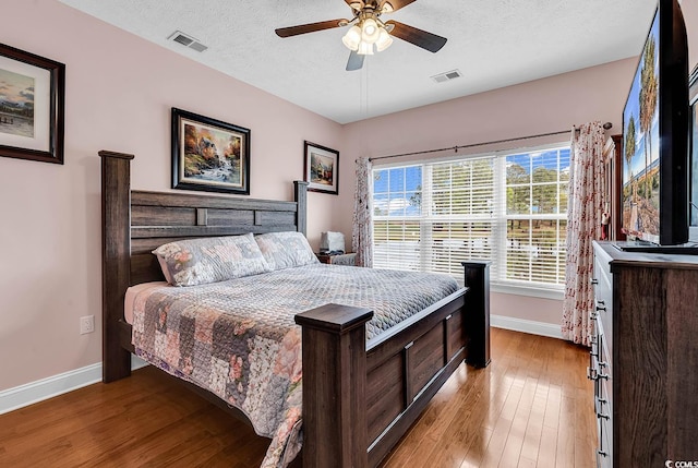 5090 Windsor Green Way Unit 103, Myrtle Beach, SC 29579 - bedroom featuring wood finished floors, a textured ceiling, and ceiling fan