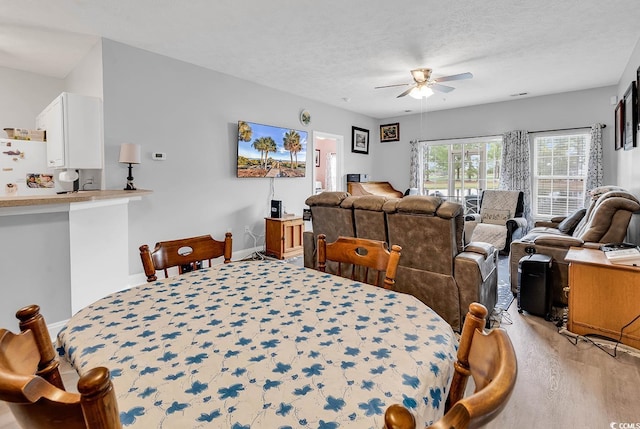5090 Windsor Green Way Unit 103, Myrtle Beach, SC 29579 - dining area with a ceiling fan, light wood-type flooring, and a textured ceiling