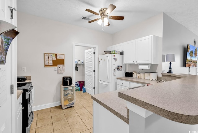 5090 Windsor Green Way Unit 103, Myrtle Beach, SC 29579 - kitchen with freestanding refrigerator, range, a ceiling fan, light tile patterned floors, and white cabinetry