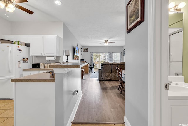 5090 Windsor Green Way Unit 103, Myrtle Beach, SC 29579 - kitchen with a ceiling fan, freestanding refrigerator, white cabinets, a textured ceiling, and recessed lighting