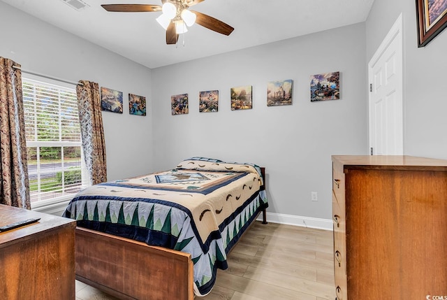 5090 Windsor Green Way Unit 103, Myrtle Beach, SC 29579 - bedroom featuring light wood-style flooring and a ceiling fan