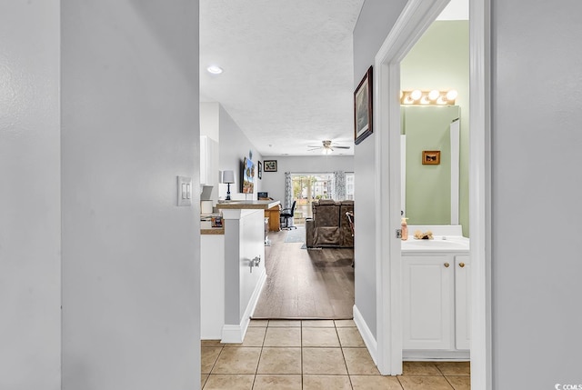 5090 Windsor Green Way Unit 103, Myrtle Beach, SC 29579 - hallway with light tile patterned floors and a textured ceiling