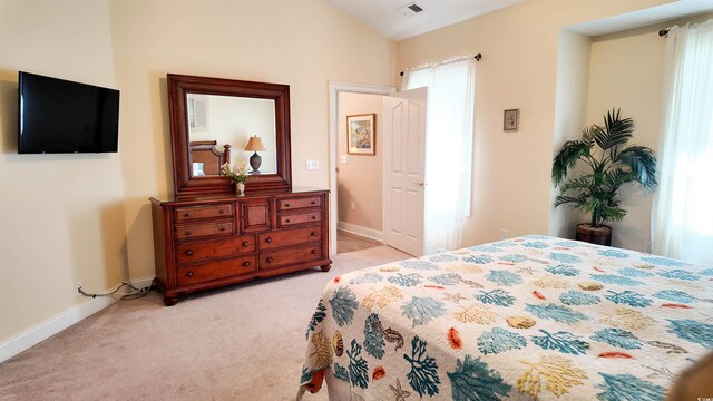 bedroom featuring visible vents, baseboards, and light carpet