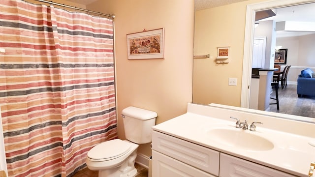 bathroom featuring a shower with shower curtain, vanity, a textured ceiling, toilet, and wood finished floors