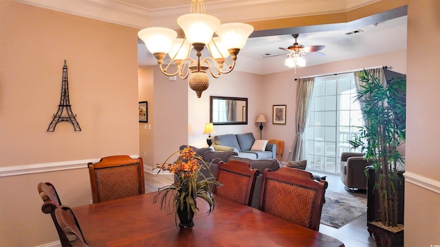 dining space featuring visible vents, ceiling fan with notable chandelier, ornamental molding, and wood finished floors