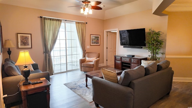living area with ceiling fan, wood finished floors, and baseboards