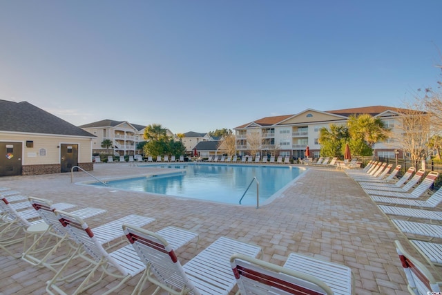 pool with a patio and a residential view