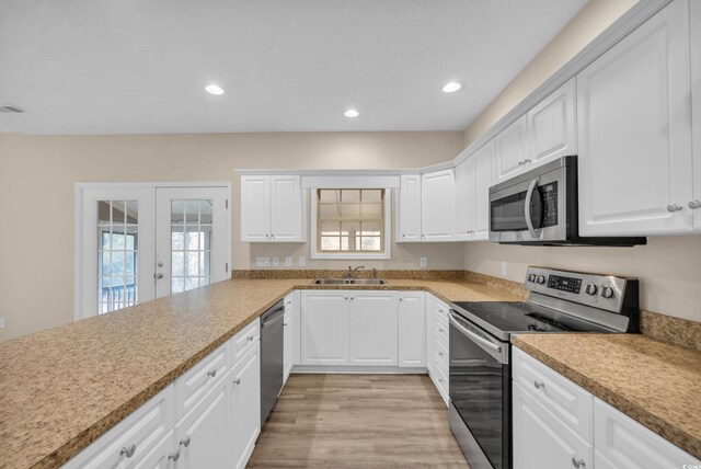 1545 Spinnaker Dr Unit 2C, North Myrtle Beach, SC 29582 - kitchen featuring stainless steel appliances, light wood finished floors, a sink, white cabinetry, and recessed lighting