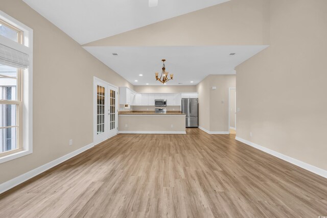 1545 Spinnaker Dr Unit 2C, North Myrtle Beach, SC 29582 - unfurnished living room featuring a chandelier, light wood finished floors, baseboards, high vaulted ceiling, and recessed lighting