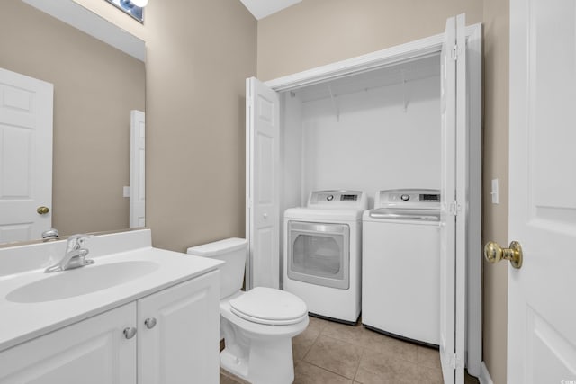 1545 Spinnaker Dr Unit 2C, North Myrtle Beach, SC 29582 - bathroom featuring vanity, independent washer and dryer, toilet, and tile patterned flooring