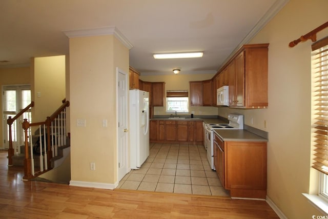 331 S Willow Dr, Surfside Beach, SC 29575 - kitchen with white appliances, light wood-style flooring, crown molding, brown cabinets, and a sink