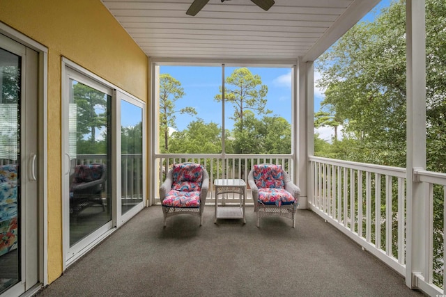 unfurnished sunroom featuring a ceiling fan