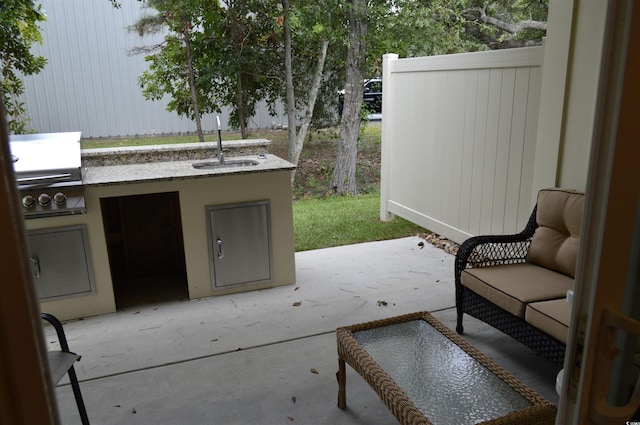 view of patio / terrace with a sink, an outdoor kitchen, and a grill