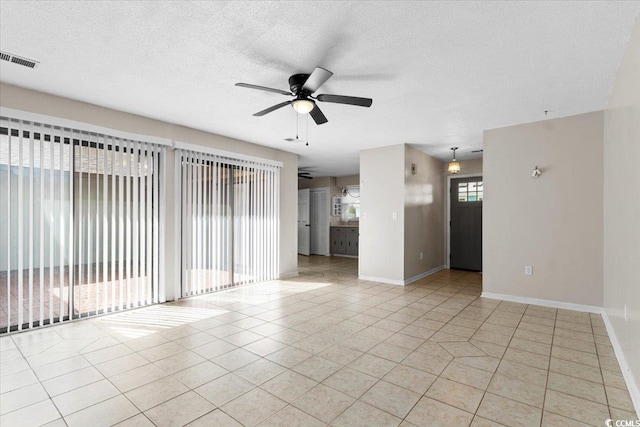 2108 Brunswick Cir, Little River, SC 29566 - unfurnished living room with a ceiling fan, light tile patterned flooring, and a textured ceiling