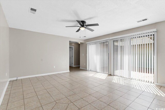 2108 Brunswick Cir, Little River, SC 29566 - unfurnished room featuring a ceiling fan, light tile patterned flooring, and a textured ceiling