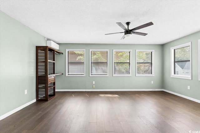 2108 Brunswick Cir, Little River, SC 29566 - unfurnished room featuring a ceiling fan, dark wood-style floors, a textured ceiling, and healthy amount of natural light