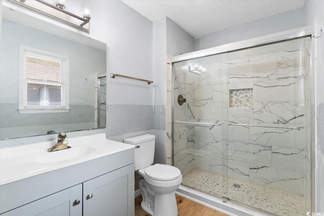 2108 Brunswick Cir, Little River, SC 29566 - bathroom with a marble finish shower, vanity, a textured ceiling, wood finished floors, and tile walls
