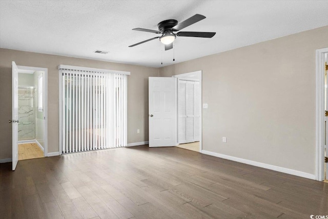 2108 Brunswick Cir, Little River, SC 29566 - unfurnished bedroom with wood finished floors, a ceiling fan, and ensuite bath