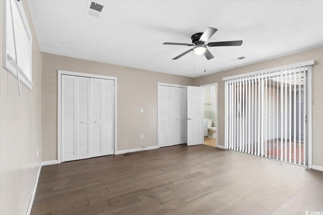 2108 Brunswick Cir, Little River, SC 29566 - unfurnished bedroom featuring wood finished floors, multiple closets, connected bathroom, and ceiling fan