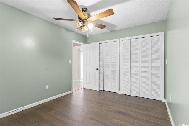 2108 Brunswick Cir, Little River, SC 29566 - unfurnished bedroom with two closets, wood finished floors, and ceiling fan